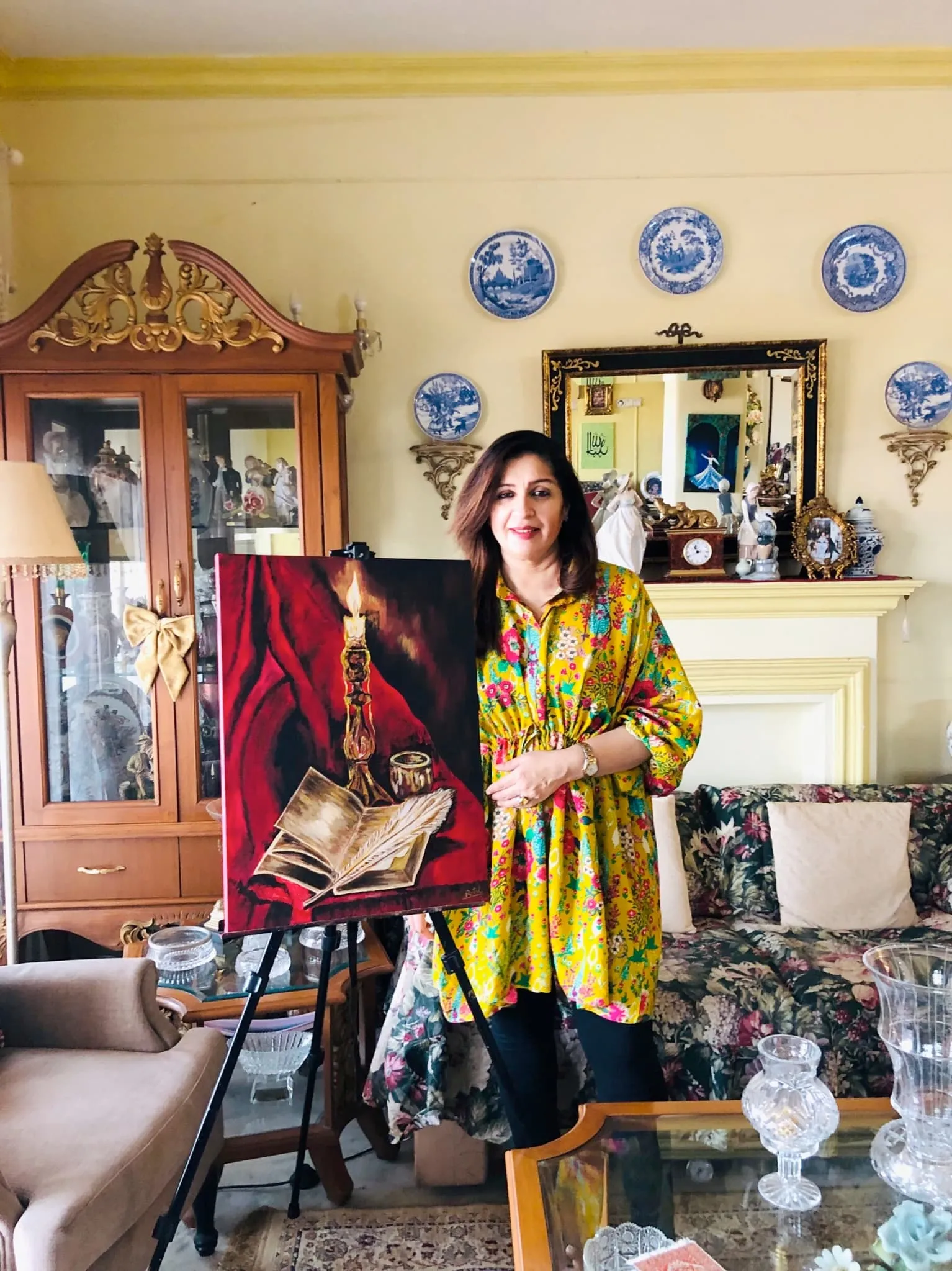 Butul Razvi in her art studio with paintings